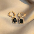 A pair of geometric quadrilateral copper earrings with black zircon stones in a French court retro style, colour E2506 Black.