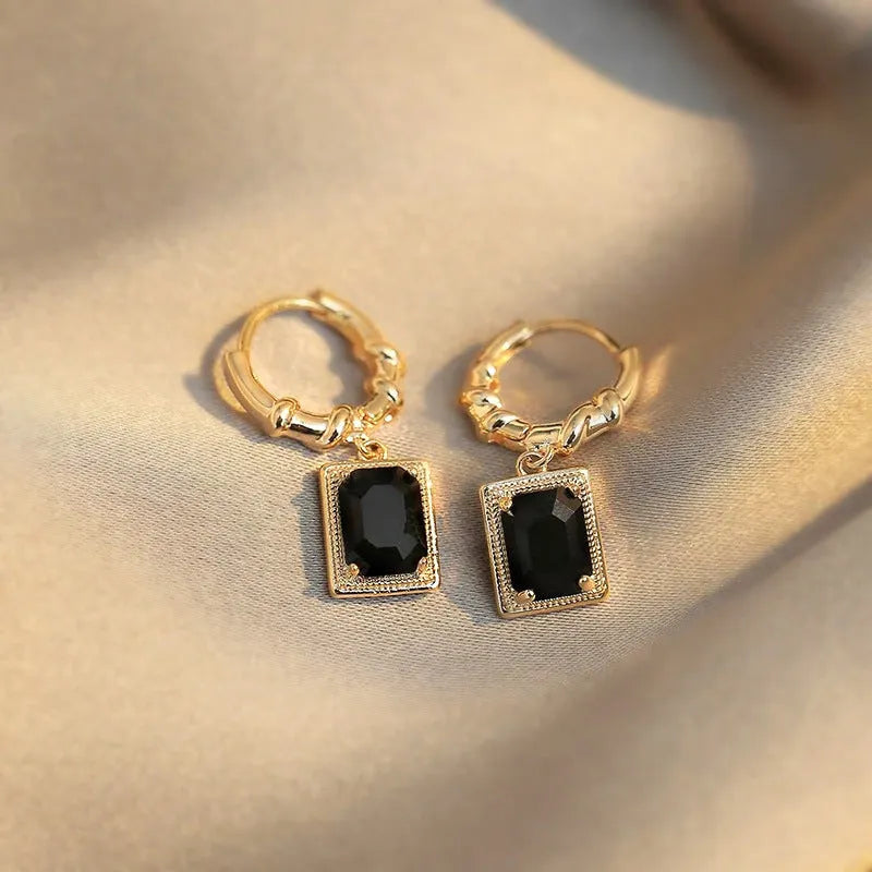 A pair of geometric quadrilateral copper earrings with black zircon stones in a French court retro style, colour E2506 Black.