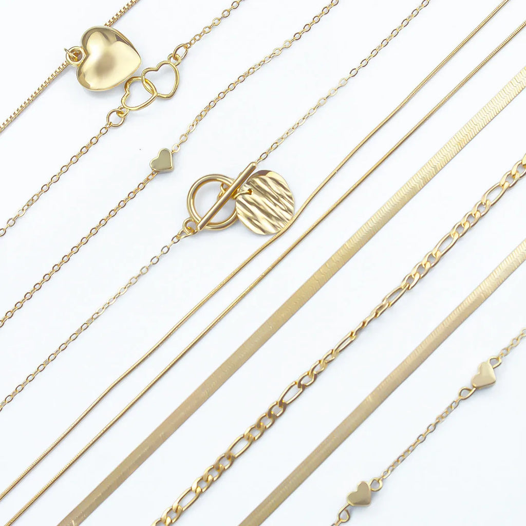 Set of ten gold electroplated women's necklaces with snake bone chains and alloy pendants.