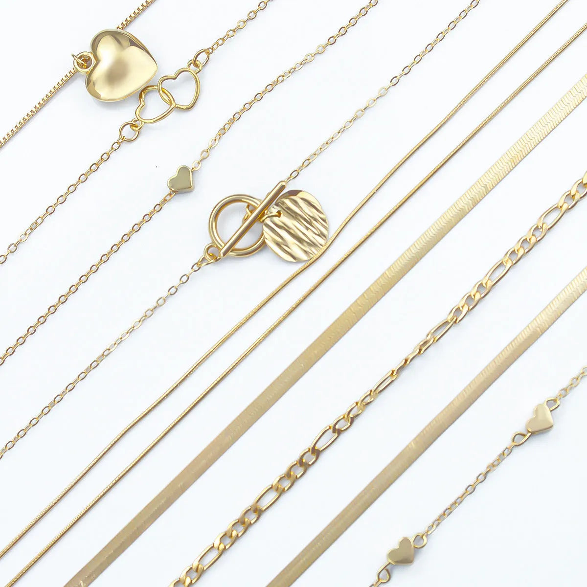 Set of ten gold electroplated women's necklaces with snake bone chains and alloy pendants.