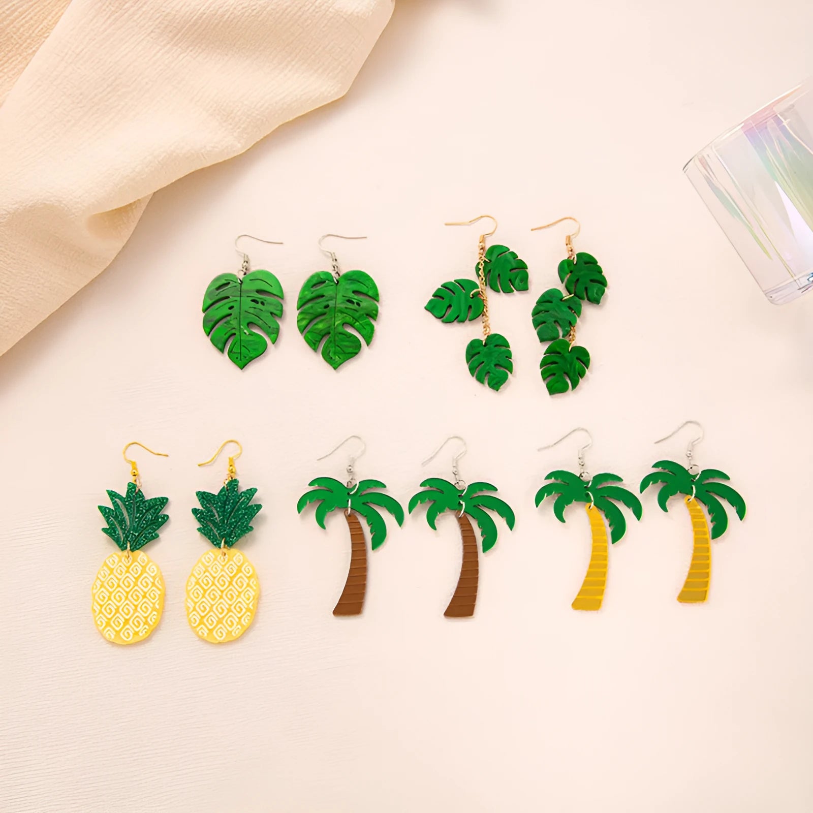 Acrylic drop-shaped earrings with coconut leaf pattern in one of five colours on an alloy hook.