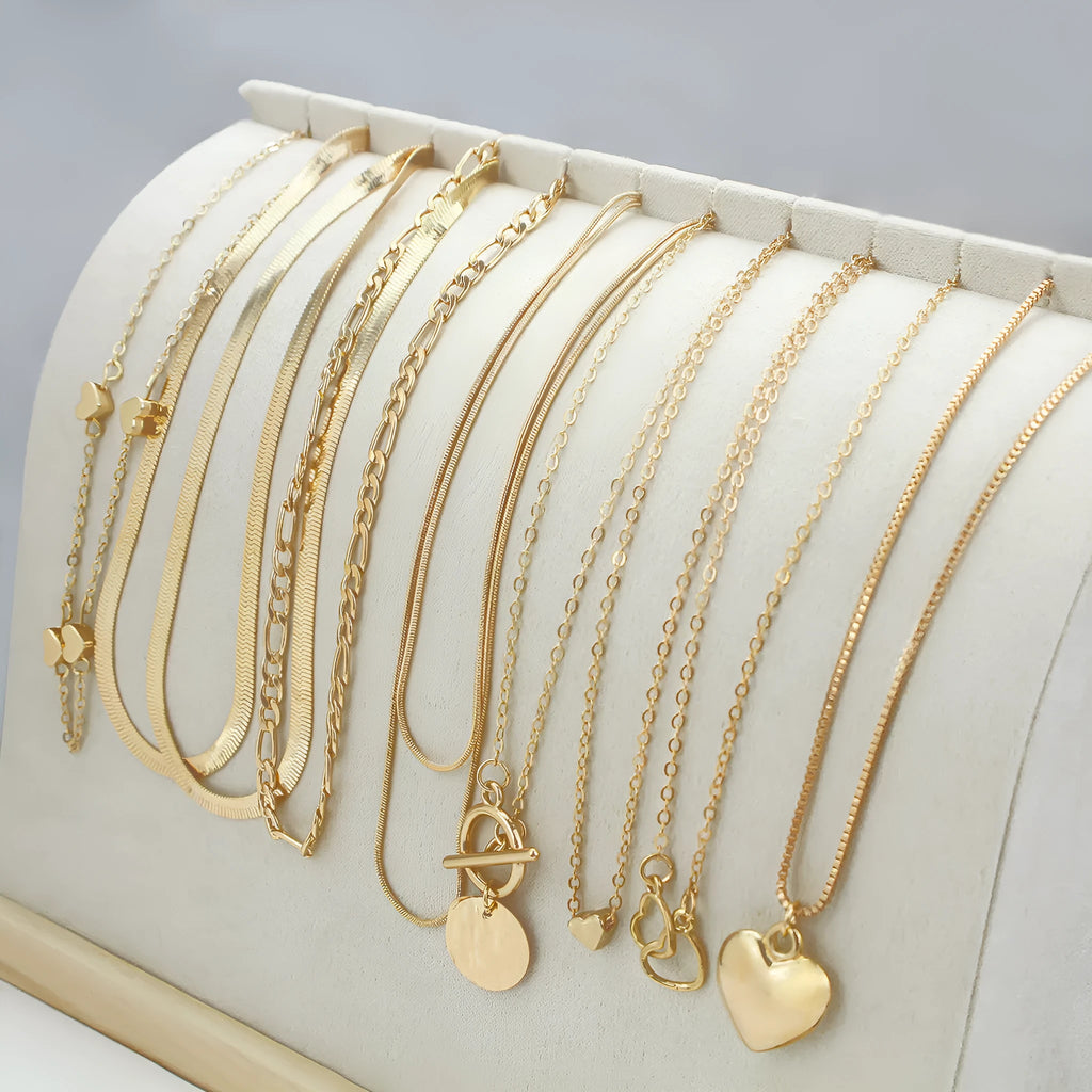 Set of ten gold electroplated women's necklaces with snake bone chains and alloy pendants.
