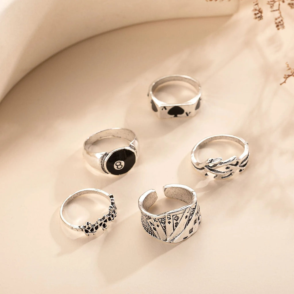 Black alloy ring with a raised spade card design on a band for women.