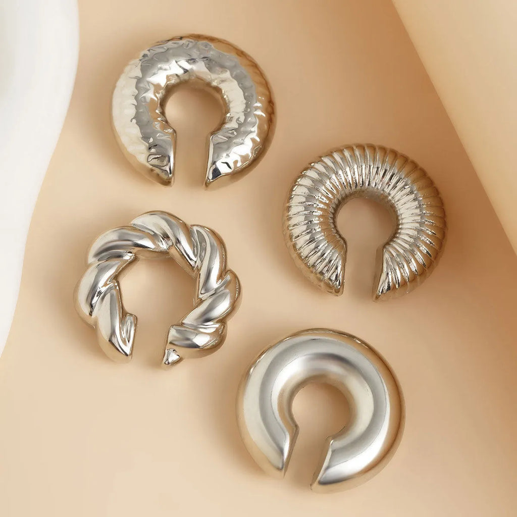 Set of four geometric clip-on earrings in gold and silver finishes for women without pierced ears
