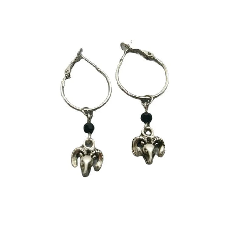 Silver alloy round hoop earrings with a Tibetan antelope design detail.