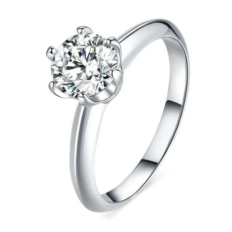 A pair of heart-shaped silver couple's rings with dragon phoenix decoration and an adjustable opening.