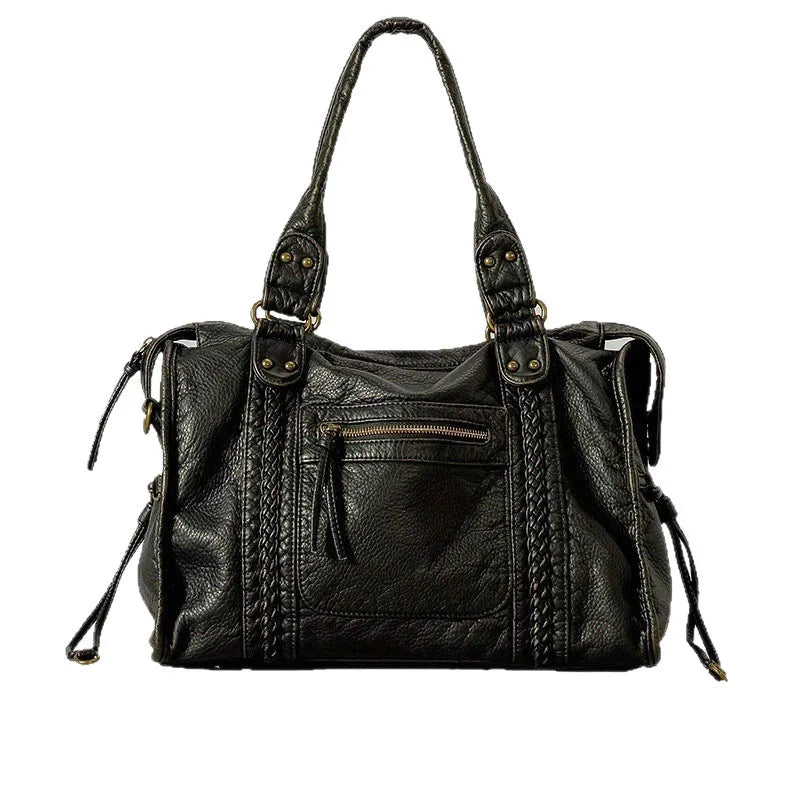 Women's European retro motorcycle messenger bag in bright black with golden edge showing weaving details and shoulder strap
