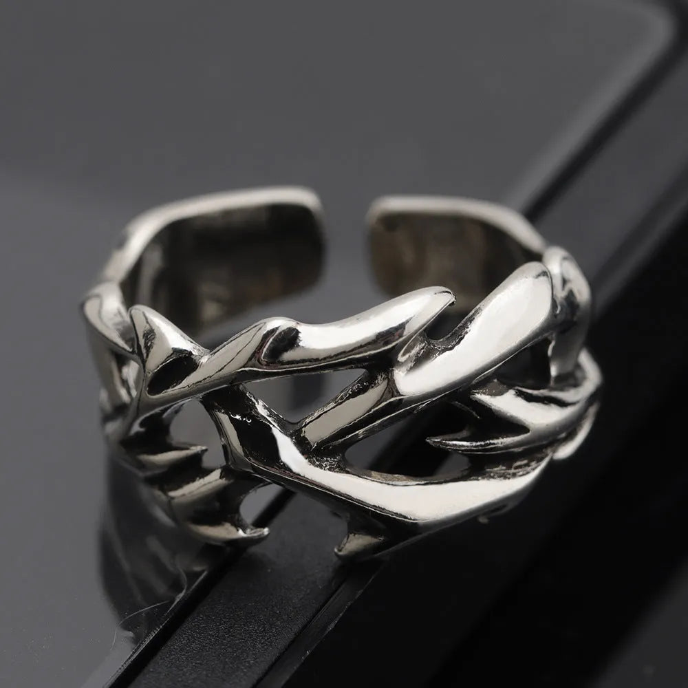 Copper adjustable ring with geometric thorn and flower design in J2150 colour on a hand.