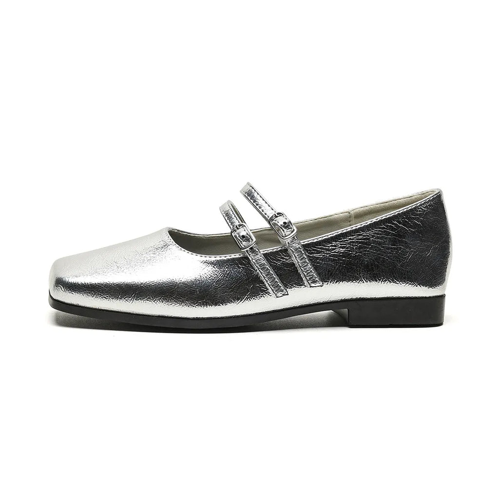 Women's silver genuine leather Mary Jane flats with a cross buckle strap and low flat heel.