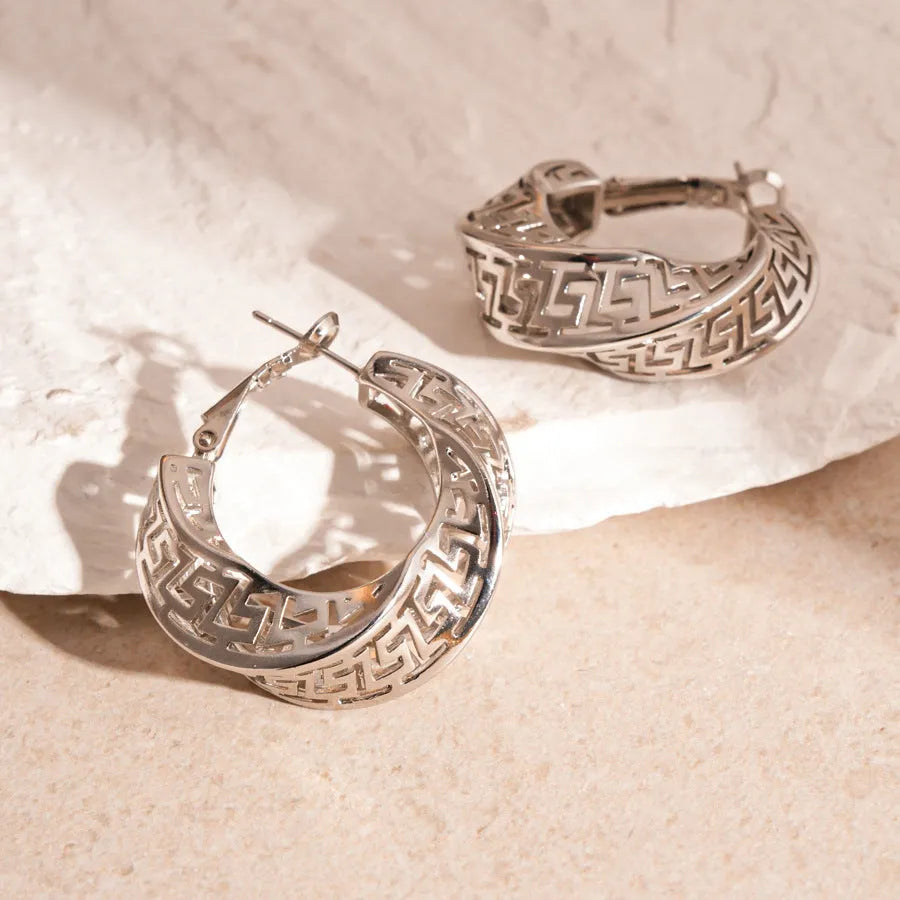 Twisted geometric hollow stud earrings in gold or silver finish with exaggerated round design