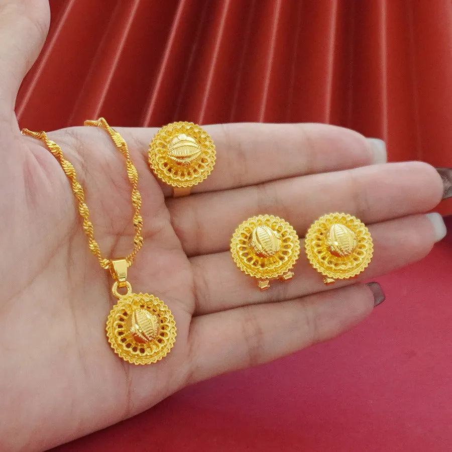 Gold-plated three-piece jewellery set with necklace, earrings, and ring featuring floral design patterns