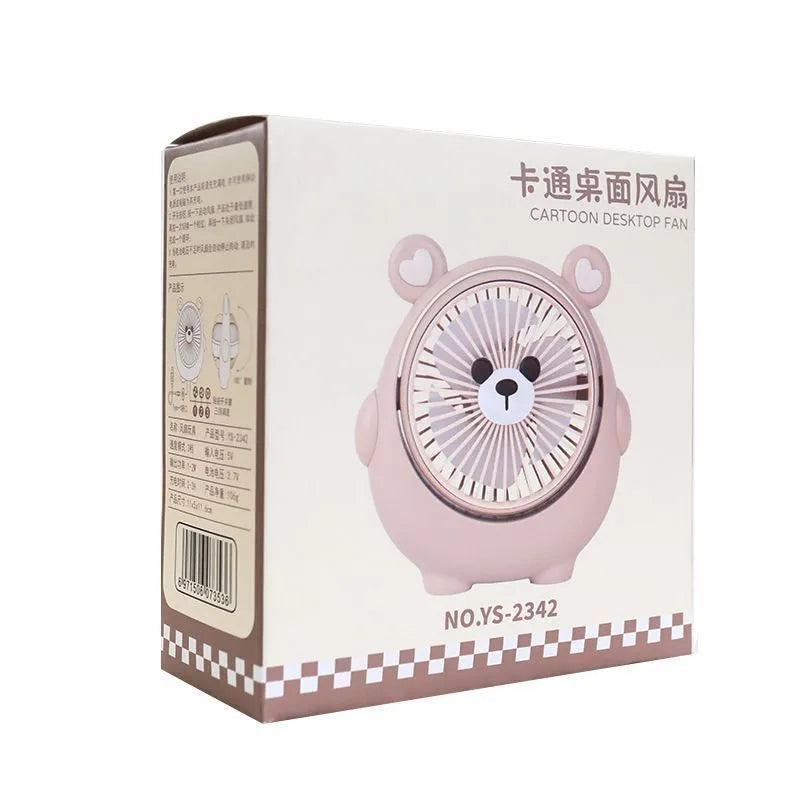 USB-powered desktop electric fan in a puppy-themed colour on a desk.