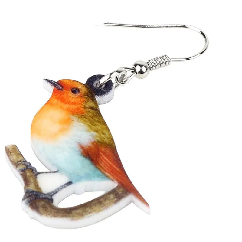 Acrylic blue titmouse bird and snake design pendant earrings on a white background.
