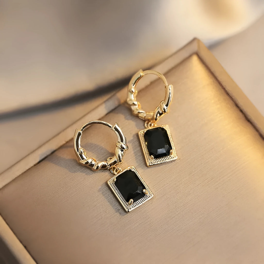 A pair of geometric quadrilateral copper earrings with black zircon stones in a French court retro style, colour E2506 Black.