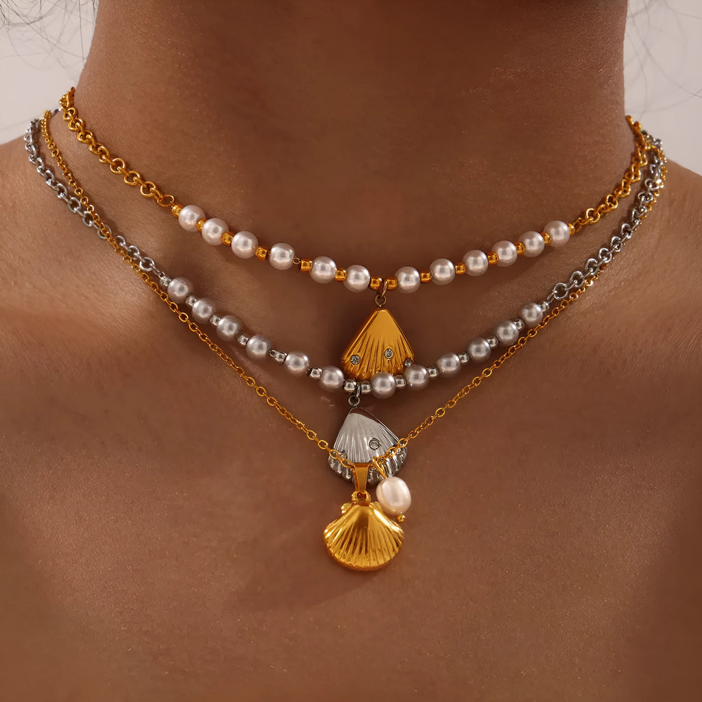 Gold tone vintage shell pendant necklace with a freshwater pearl bead on an O-shaped titanium steel chain.