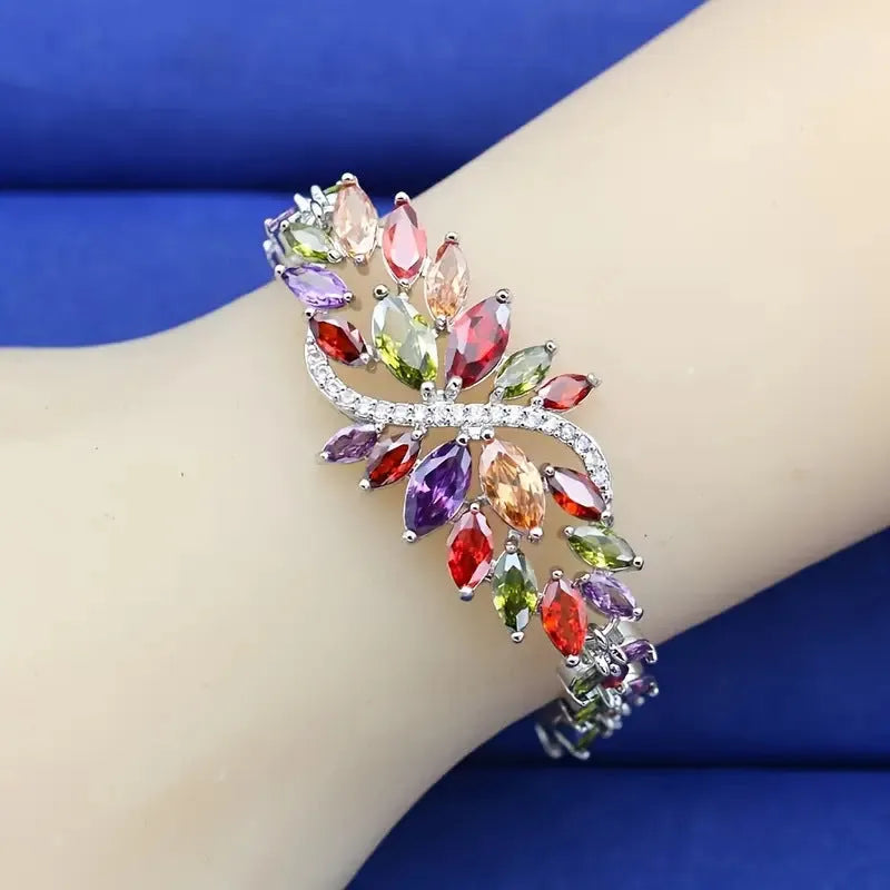 Gold electroplated bracelet with coloured zircon stones and ice flowers pattern on copper.