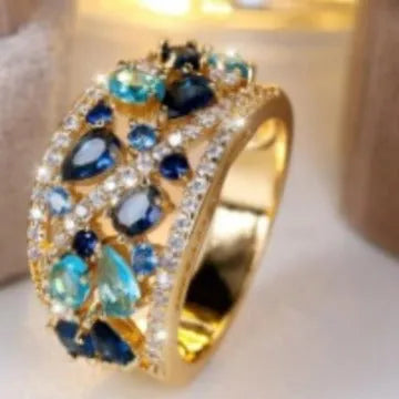 Women's round hollow fashion ring in gold or platinum with a diamond or blue sapphire stone.