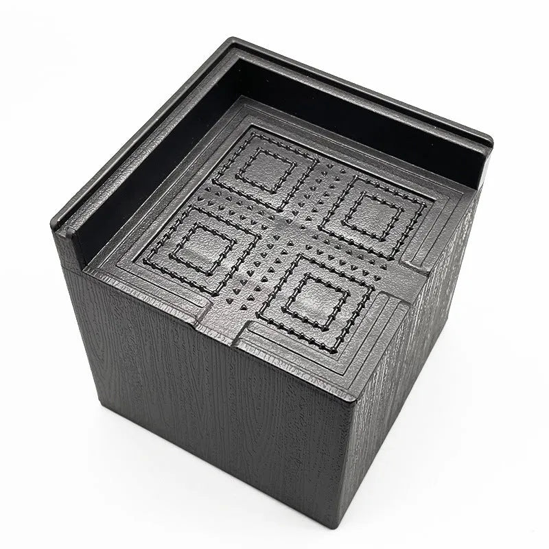Four black plastic bed risers for increasing furniture height