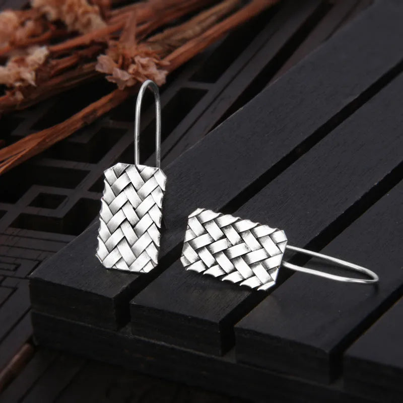 Silver geometric plaid pattern drop earrings with woven diamond design
