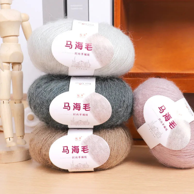 A ball of mohair yarn for a hand-woven DIY scarf kit, shown with a selection of its 34 colour options.