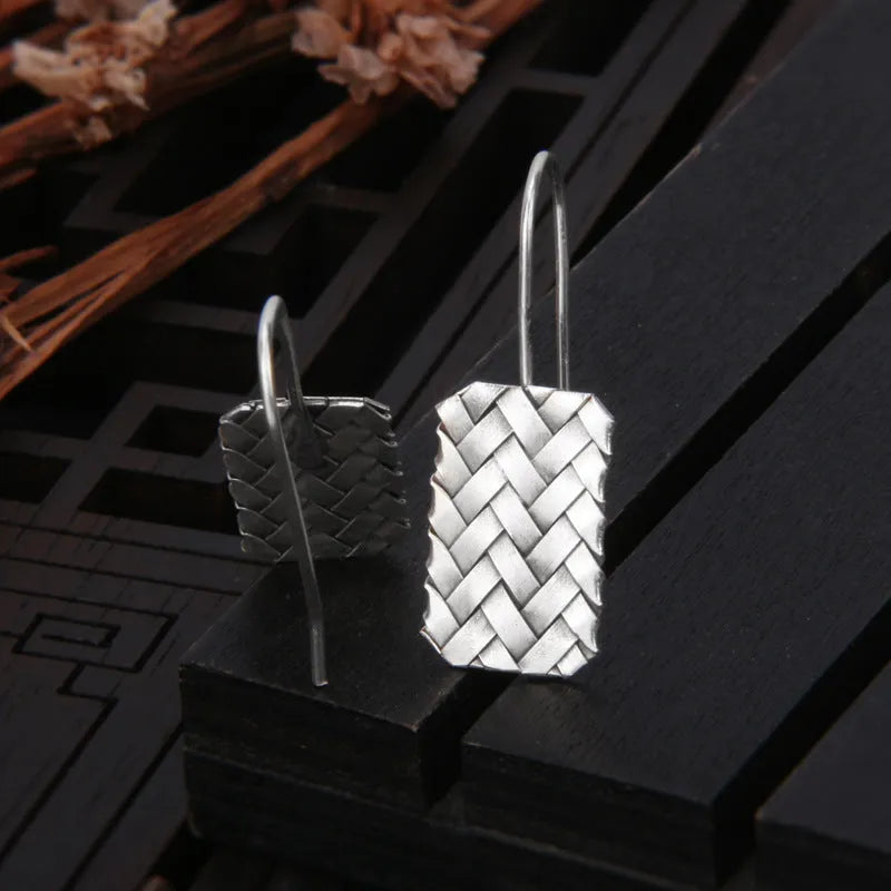 Silver geometric plaid pattern drop earrings with woven diamond design