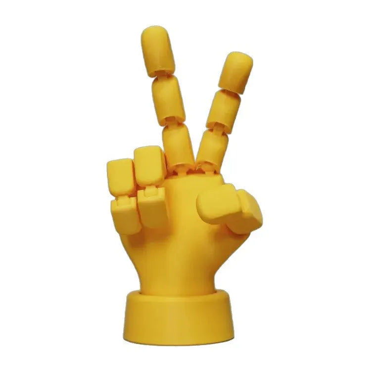 Yellow articulated PLA hand prop with movable fingers on a neutral background.