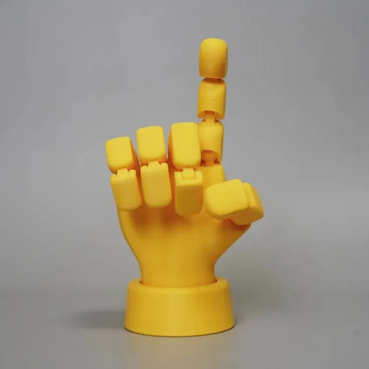 Yellow articulated PLA hand prop with movable fingers on a neutral background.