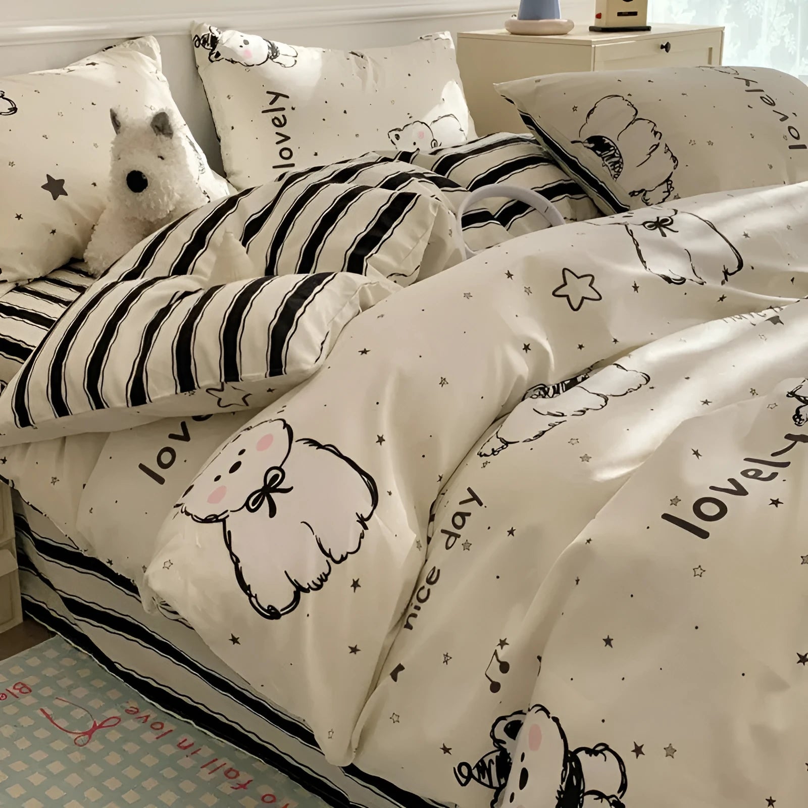 Cartoon dog pattern pure cotton duvet cover and pillowcases from a four-piece bedding set laid on a bed.