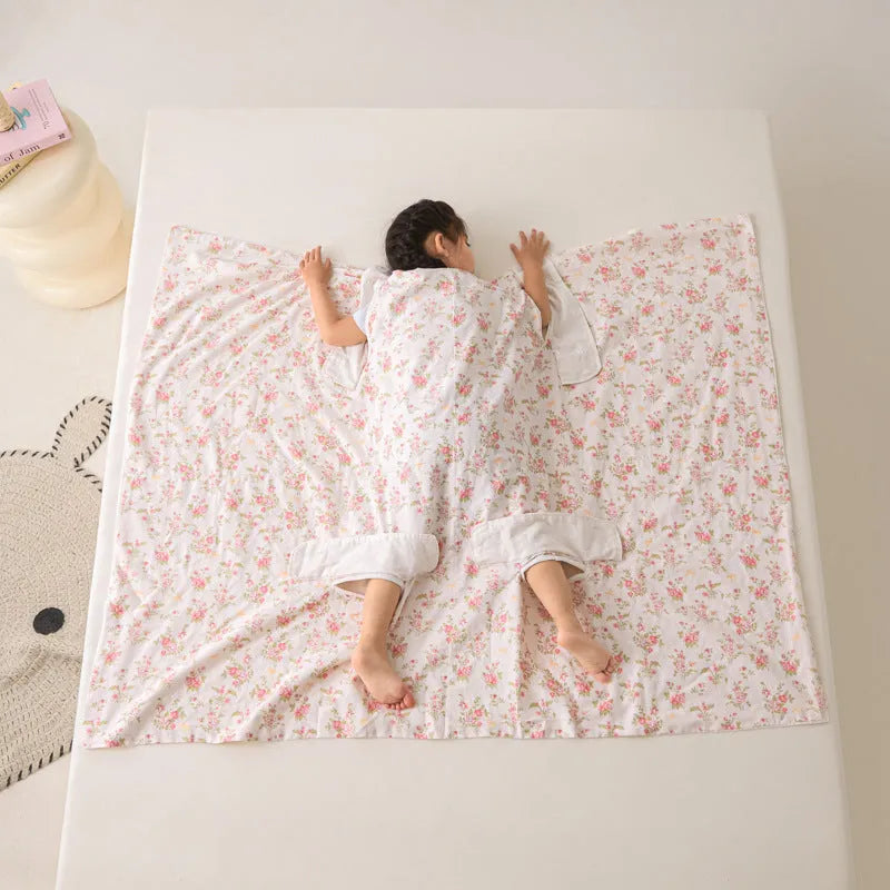 Anti-kick sleeping bag style blanket in a colourful pattern on a bed.