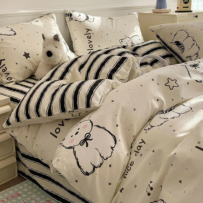 Cartoon dog pattern pure cotton duvet cover and pillowcases from a four-piece bedding set laid on a bed.