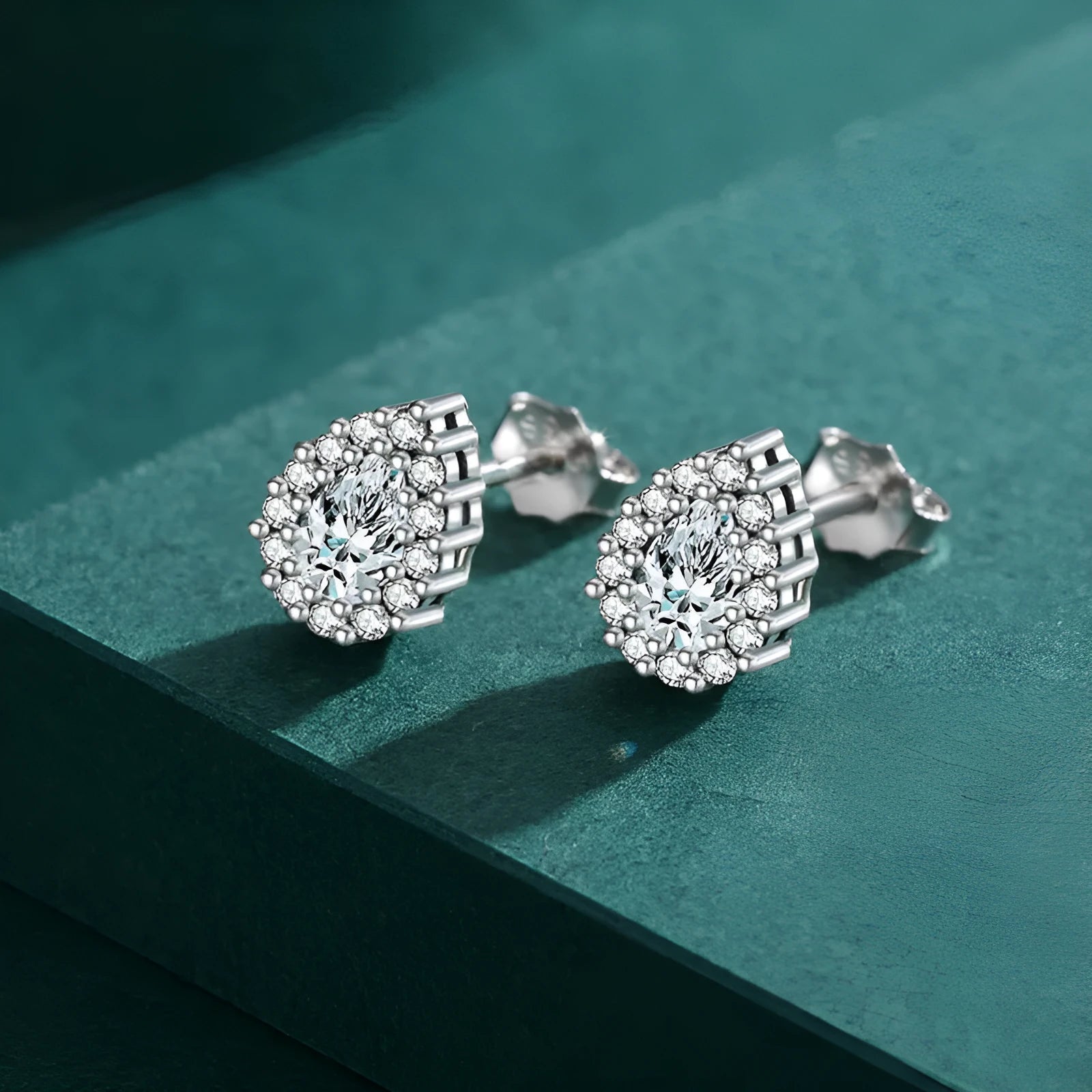 Close-up of women's silver water drop shaped ear studs made from 925 sterling silver.