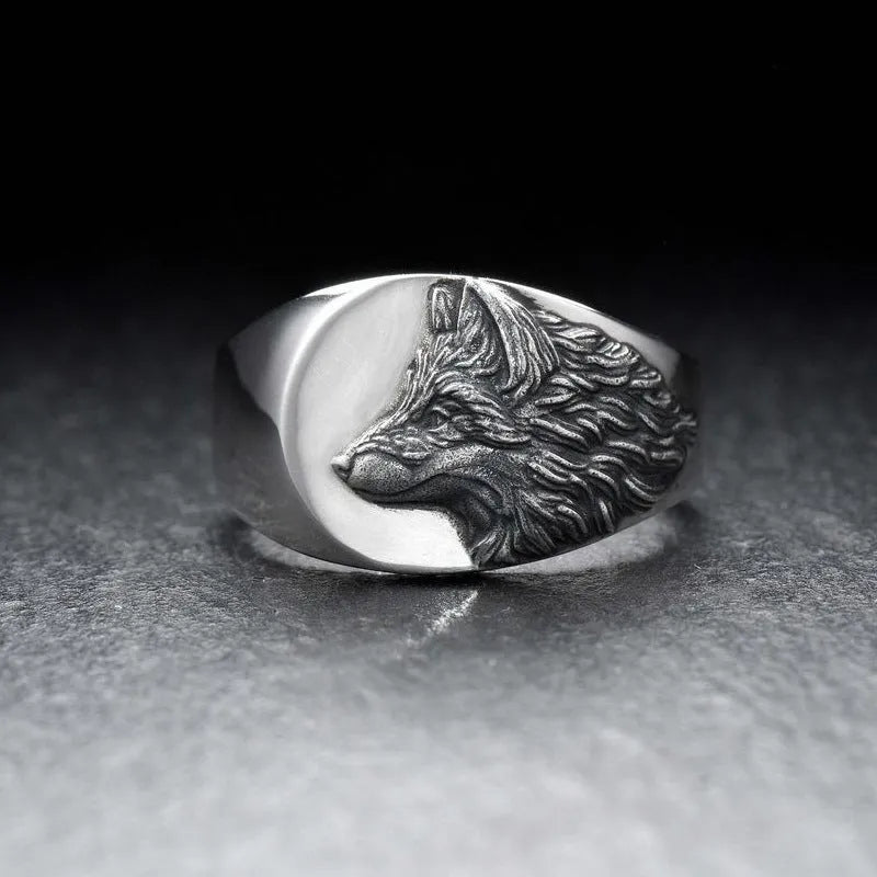 Men's silver alloy ring with a geometric wolf head design on a signet ring band.