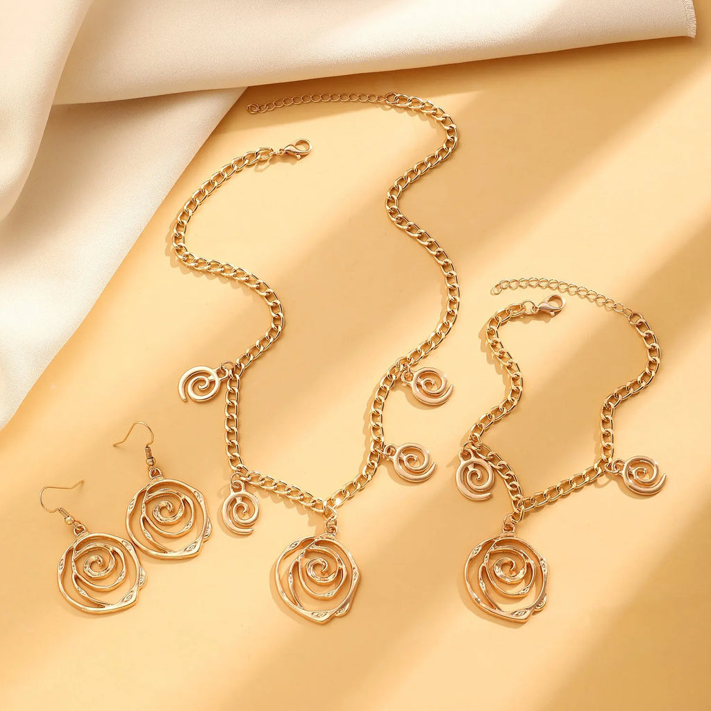 Spiral donut alloy jewellery set with necklace, bracelet, and earrings in gold or silver electroplated finish