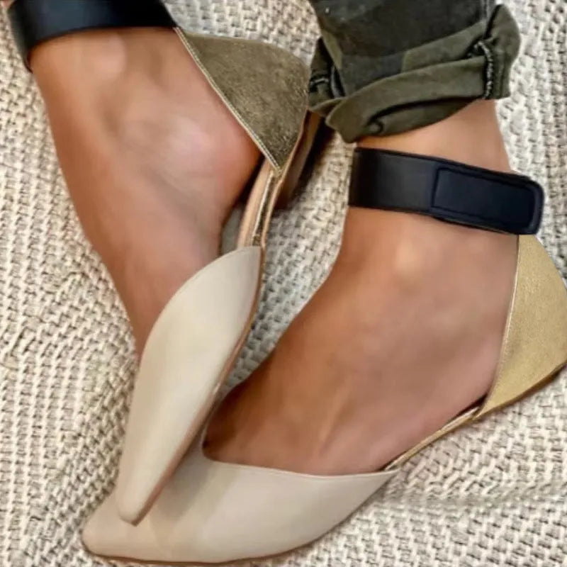 Women's beige velcro sandals with a hollowed upper design and flat heel.