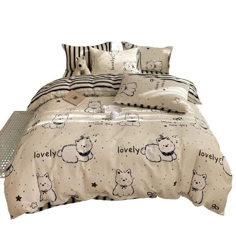 Cartoon dog pattern pure cotton duvet cover and pillowcases from a four-piece bedding set laid on a bed.