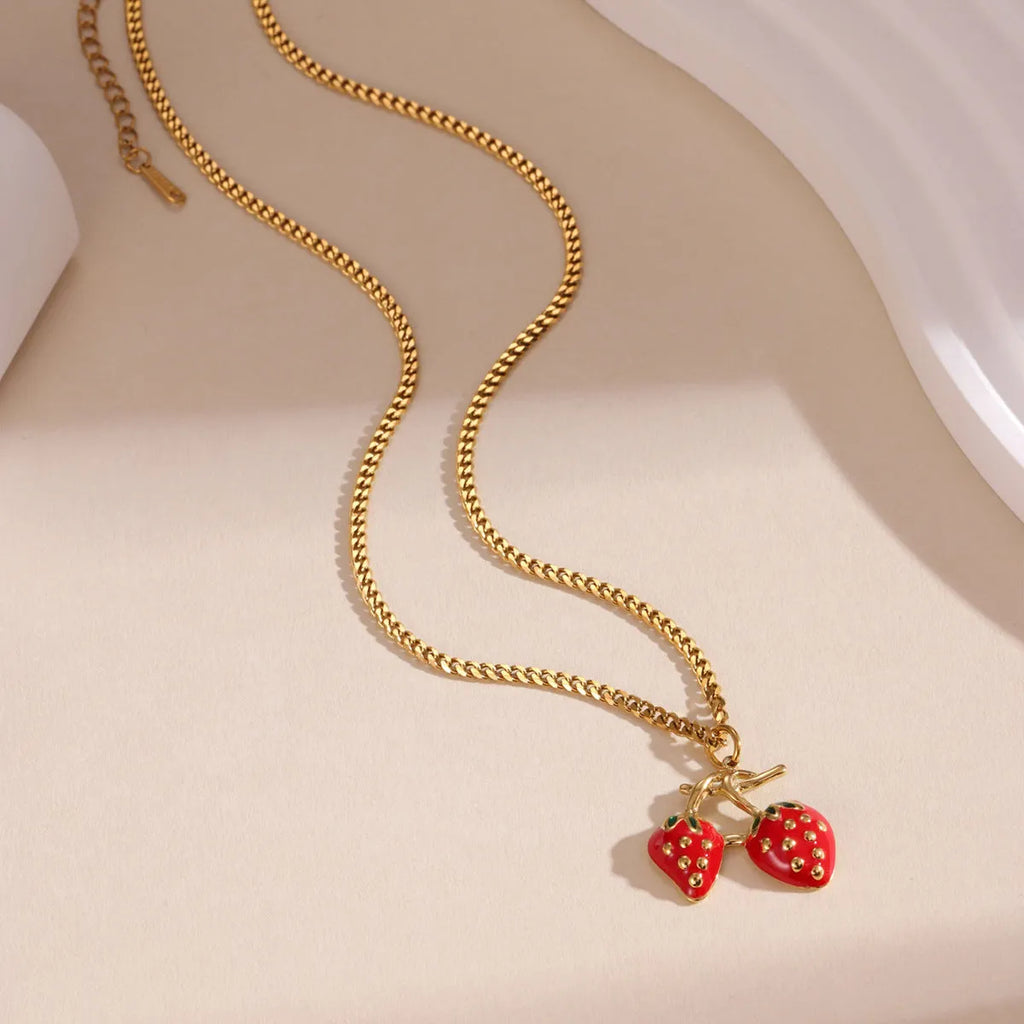 Women's summer strawberry fruit pendant necklace in red or white gradient on a steel chain.