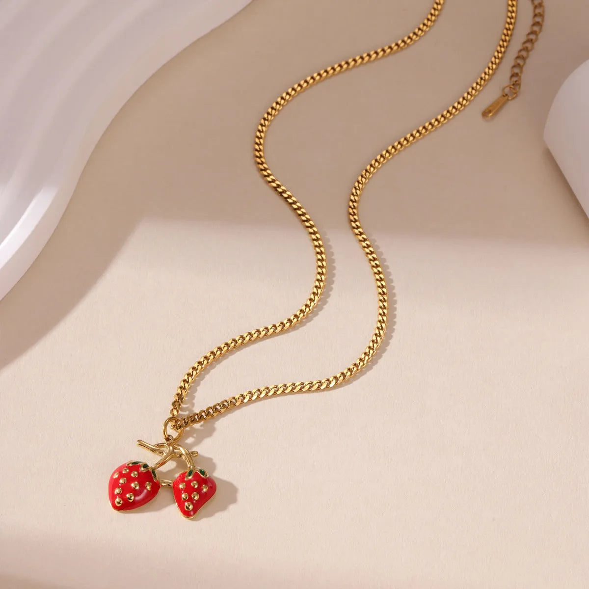 Women's summer strawberry fruit pendant necklace in red or white gradient on a steel chain.