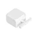 Small white Bluetooth rocker arm finger robot remote control on a grey surface.