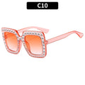Plastic fashion sunglasses in various colour and lens combinations on a plain background.