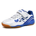 White and blue lightweight badminton shoes with a ribbed non-slip sole, shown on a court surface.