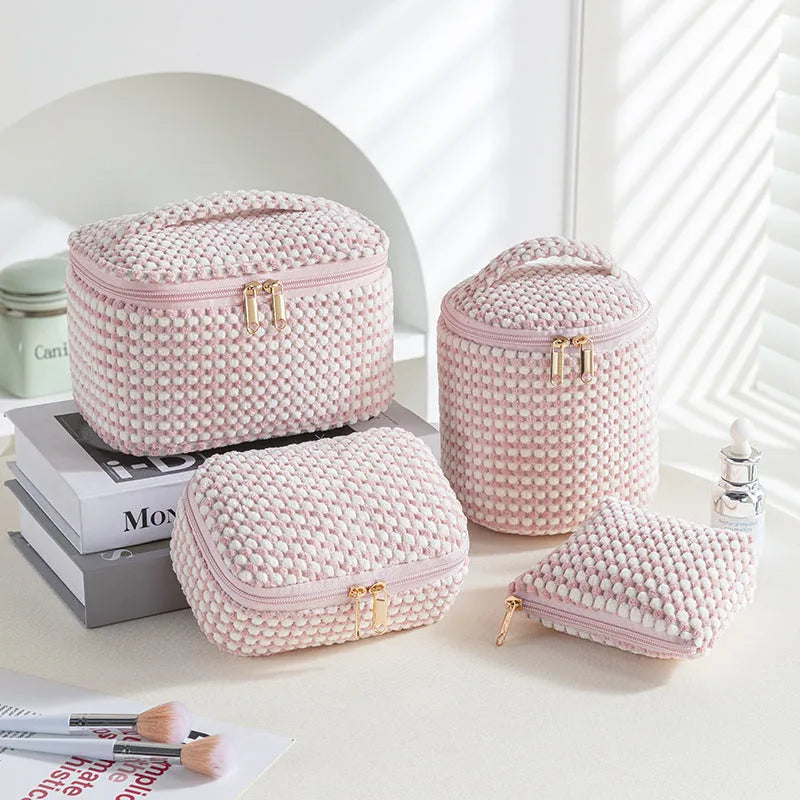 Four cube-shaped flannelette makeup bags in a set, shown in blue with dots colour