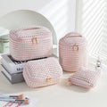 Four cube-shaped flannelette makeup bags in a set, shown in blue with dots colour