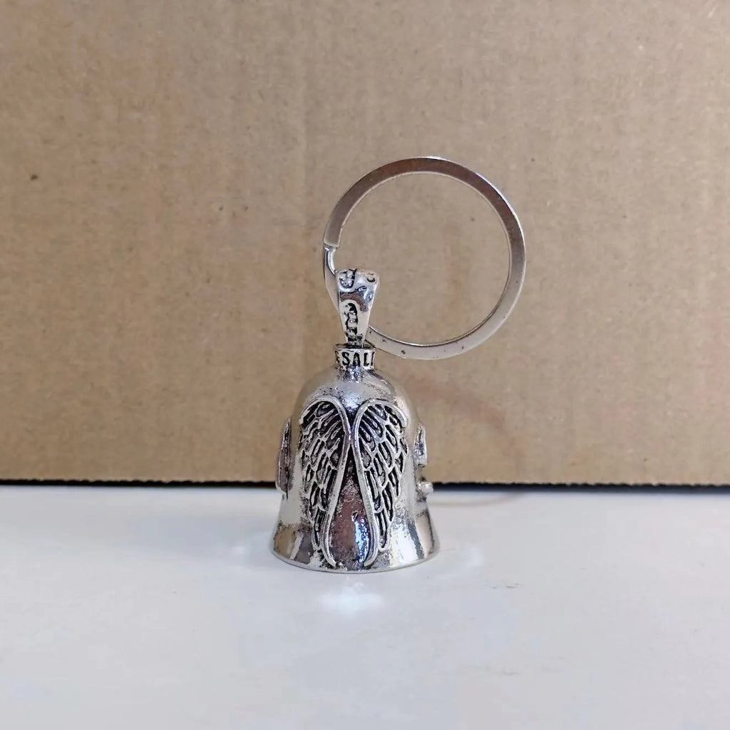 Vintage white angel feather alloy keychain and necklace on a dark background.