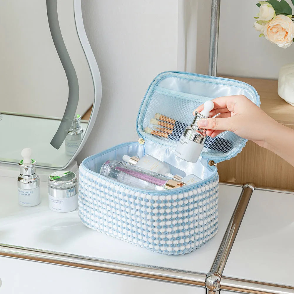 Four cube-shaped flannelette makeup bags in a set, shown in blue with dots colour