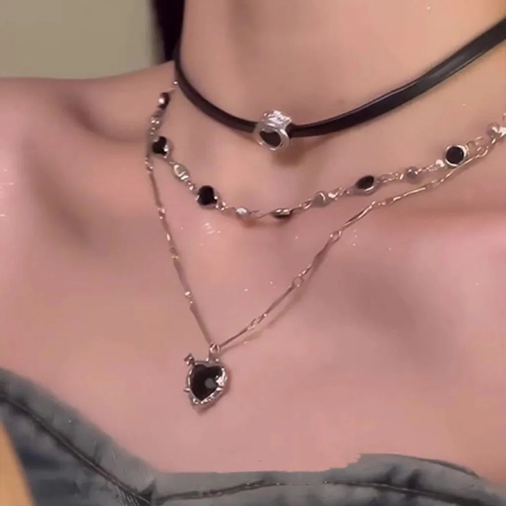 Women's creative double-layer necklace with heart-shaped crystal pendant and leather accents on an adjustable chain.