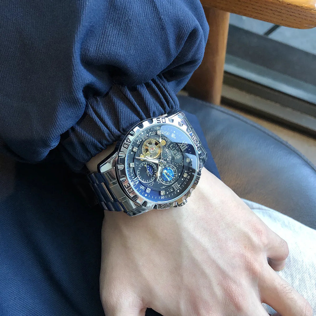 Silver men's automatic watch with black steel belt and luminous starry dial.