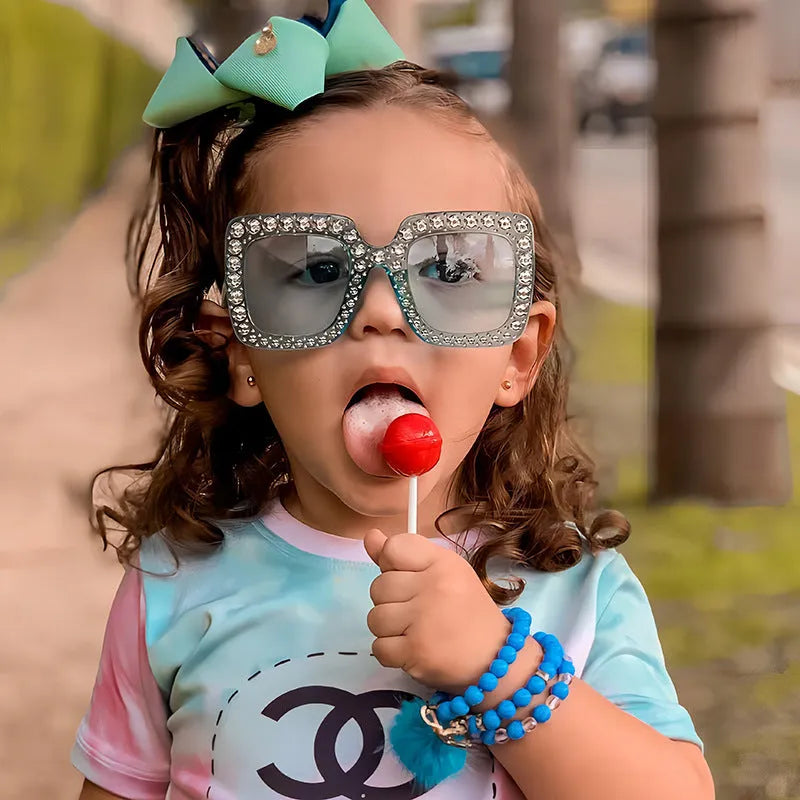 Plastic fashion sunglasses in various colour and lens combinations on a plain background.