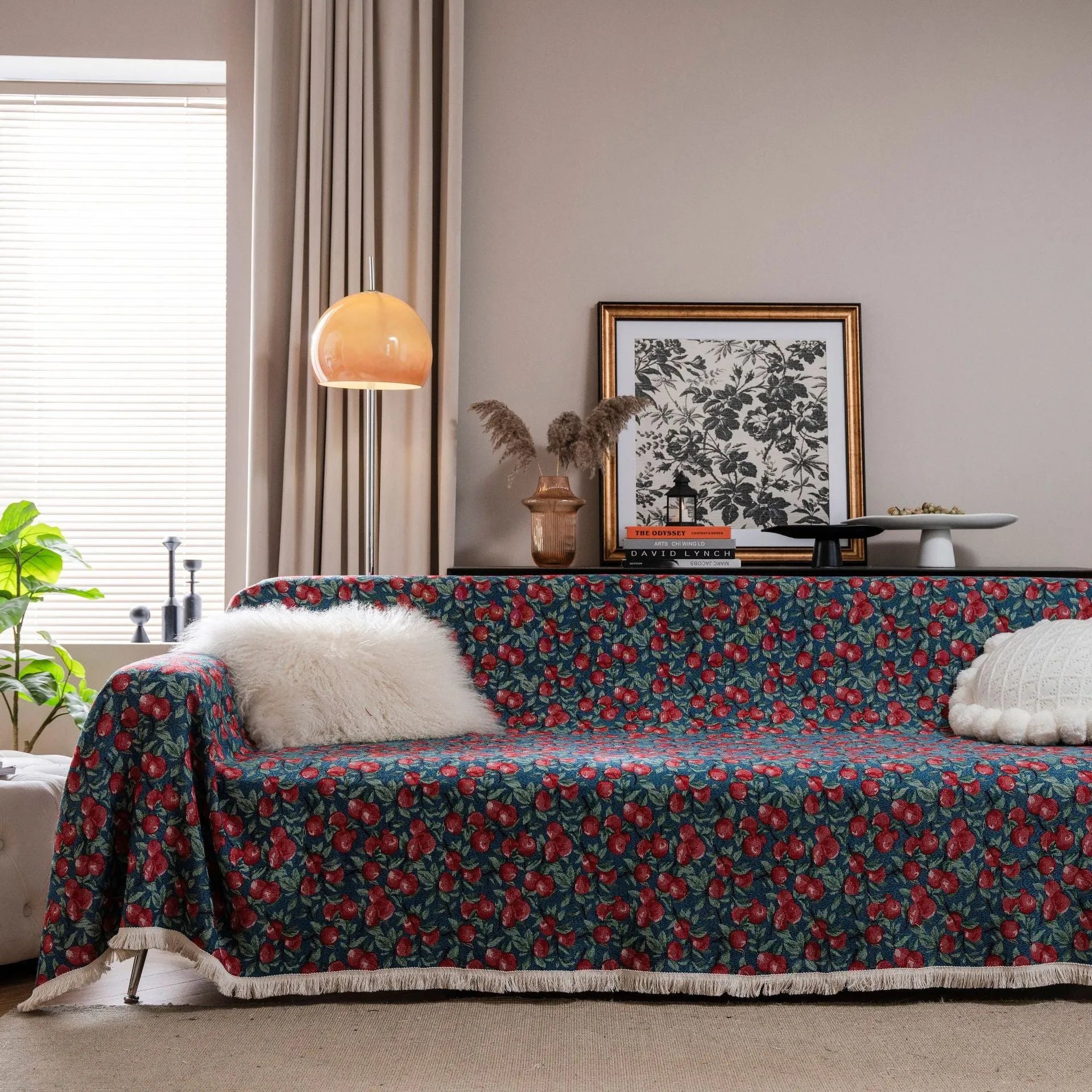 American country retro jacquard sofa cover in a cherry pattern on a white background, draped over a sofa.