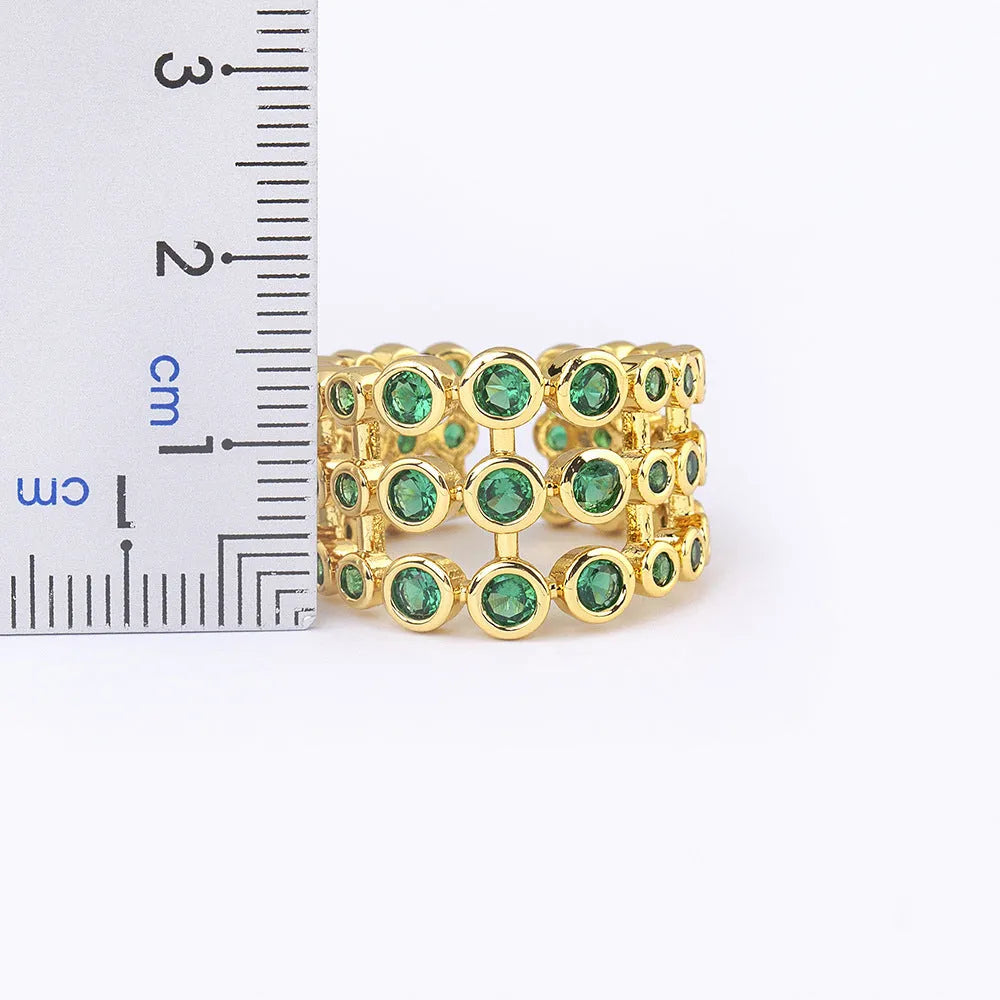 Copper ring with 18K gold plating and green zircon stones in wide band design