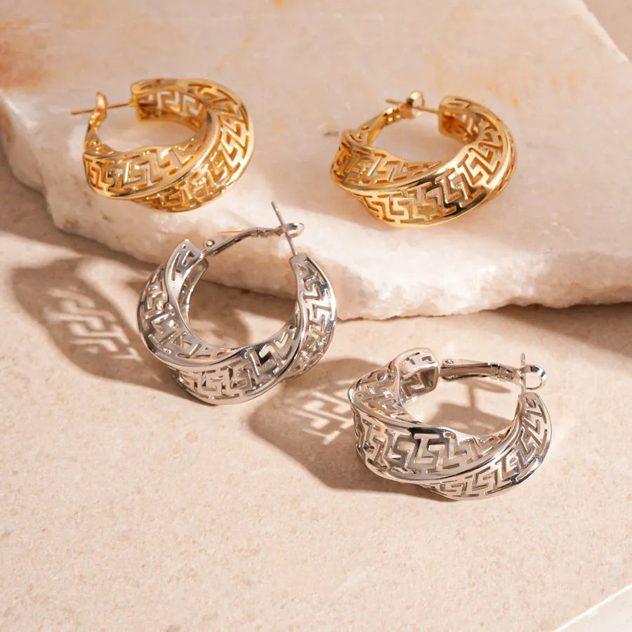 Twisted geometric hollow stud earrings in gold or silver finish with exaggerated round design